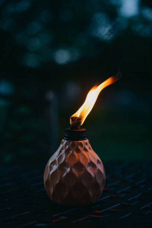 table torch insect repellant lit at night - garden decoration stock pictures, royalty-free photos & images