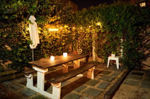table with candle lights in backyard garden in evening - garden decoration stock pictures, royalty-free photos & images