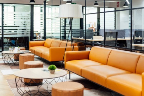 tables and sofas arranged at modern workplace - home decoration stock pictures, royalty-free photos & images