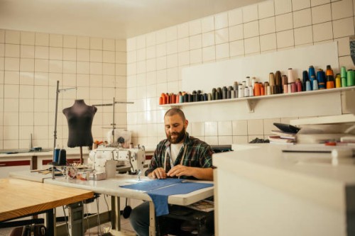 tailor working with sewing machine - fashion stock pictures, royalty-free photos & images