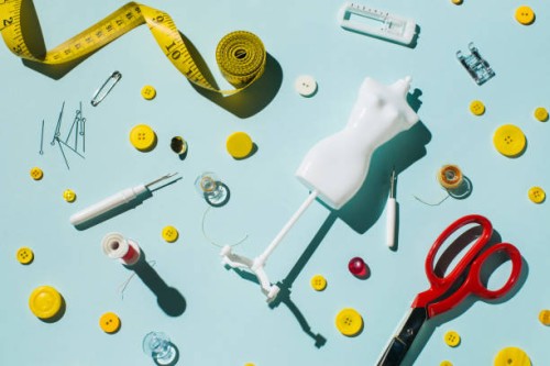 tailoring scissors and sewing supplies and accessories on blue background - fashion stock pictures, royalty-free photos & images