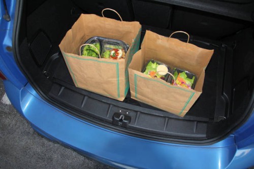 take-out food in trunk of car using curbside pick-up - junk food stock pictures, royalty-free photos & images