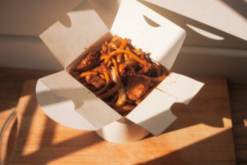 take-out meal, noodles in paper box in direct sunlight - junk food stock pictures, royalty-free photos & images