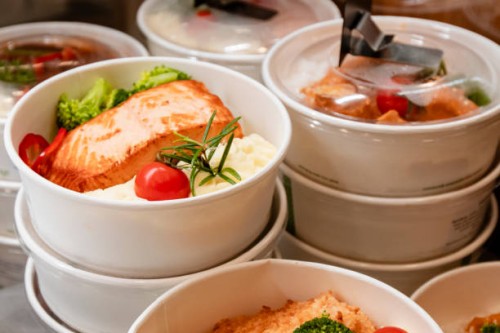 take away food in compostable containers stacked on top of each other in display fridge - junk food stock pictures, royalty-free photos & images