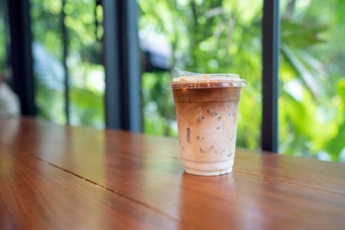 take away iced coffee on table - junk food stock pictures, royalty-free photos & images