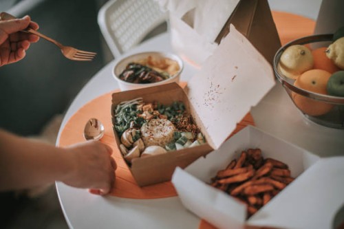 take out food chinese food at home on table with fork and spoon - junk food stock pictures, royalty-free photos & images
