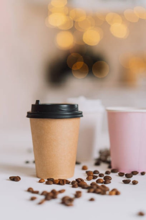 takeaway coffee in tray on white table with coffee beans against tree lights - junk food stock pictures, royalty-free photos & images
