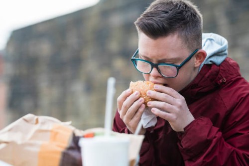 taking a bite - junk food stock pictures, royalty-free photos & images