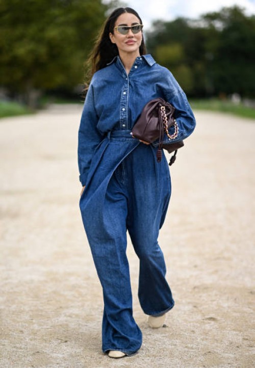 Tamara Kalinic is seen wearing a denim Loewe shirt and pants with burgundy bag and gold sunglasses outside the Loewe show during Womenswear...