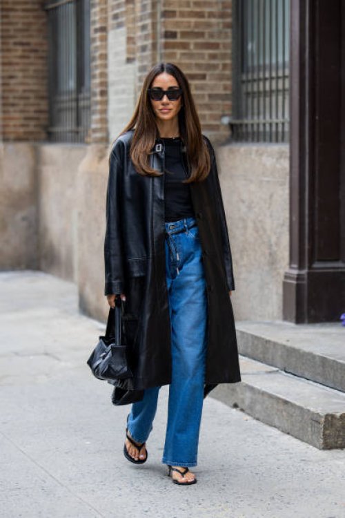 Tamara Kalinic wears black coat, denim jeans, shirt, sandals, bag outside Proenza Schouler on February 10, 2024 in New York City.