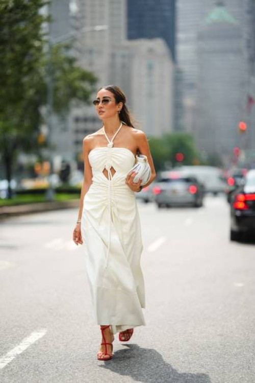 Tamara Kalinic wears sunglasses, an off-shoulder gathered long dress, a bag, outside Proenza Schouler, during New York Fashion Week, on September 09,...