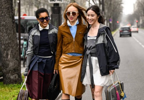 Tamu McPherson is seen wearing a Miu Miu outfit with Miu Miu brown and white bag with a guest wearing a brown jacket, tan Miu Miu skirt, black Miu...
