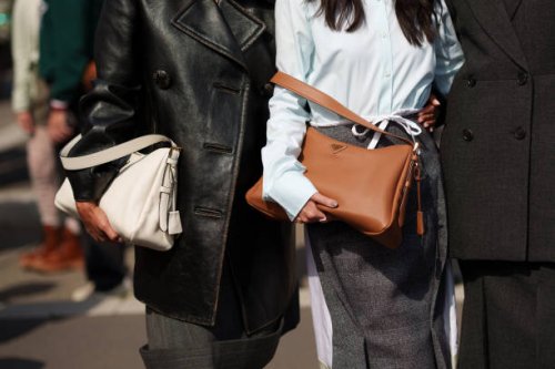 Tamu McPherson wearing a sleek black leather coat layered over a structured dress and a bag, Jenny Tsang wearing a shirt, a skirt, a bag and Proud...
