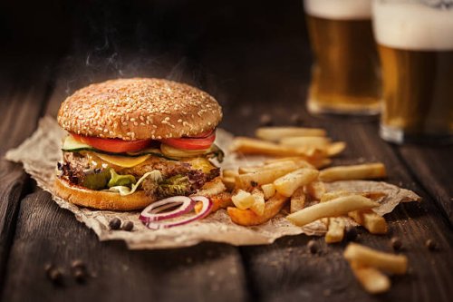 tasty hamburger with french fries and beer on wooden table - junk food stock pictures, royalty-free photos & images