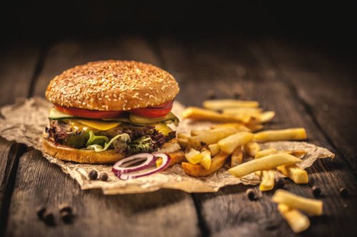 tasty hamburger with french fries on wooden table - junk food stock pictures, royalty-free photos & images