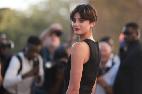 Taylor Hill is seen outside Mugler show wearing black cropped tank top and silver earrings and necklace during the Womenswear Spring/Summer 2024 as...