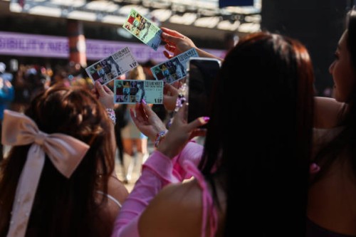 Taylor Swift fans, also known as "Swifties", hold up tickets purchased for the show at Melbourne Cricket Ground on February 16, 2024 in Melbourne,...