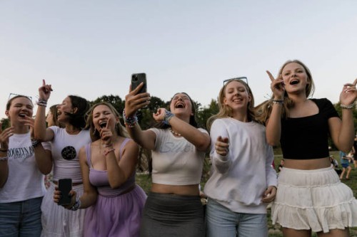 Taylor Swift's fans are singing and dancing holding their mobile phones outside the National Stadium during the Eras Tour. American singer Taylor...