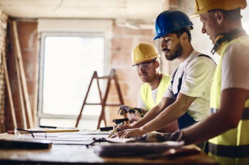 team of manual workers examining housing project while working at construction site. - home decoration stock pictures, royalty-free photos & images