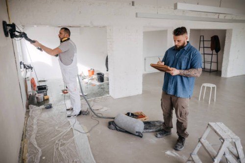 team of workers working on renovating the wall - home decoration stockfoto's en -beelden