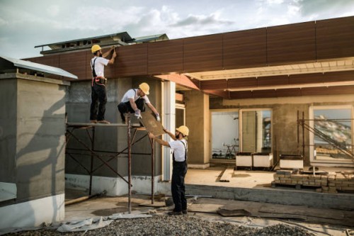 team van bouwvakarbeiders die samenwerken aan een huis exterieur. - home decoration stockfoto's en -beelden