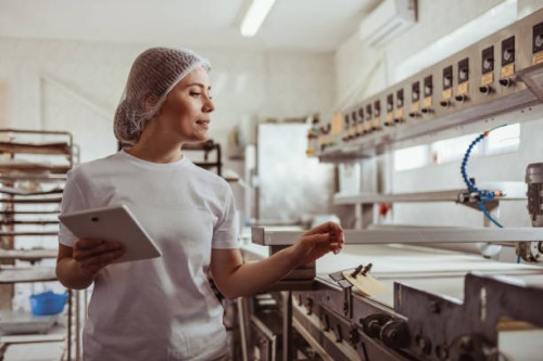 tech-savvy female baker using tablet for bakery operations - food stock pictures, royalty-free photos & images