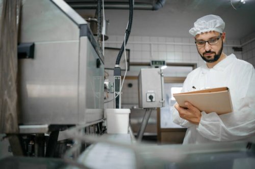 technologist expert taking parameters from industrial machine in a milk factory - food stock pictures, royalty-free photos & images