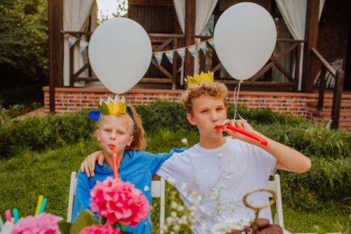 teen kids in crown birthday caps and whistles posing near birthday table - garden decoration stock pictures, royalty-free photos & images