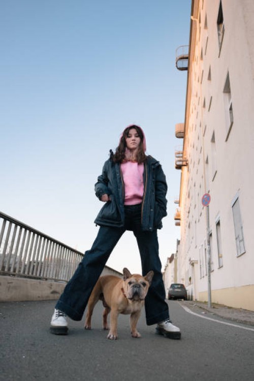 teenage girl portrait with french bulldog, urban background - fashion stock pictures, royalty-free photos & images