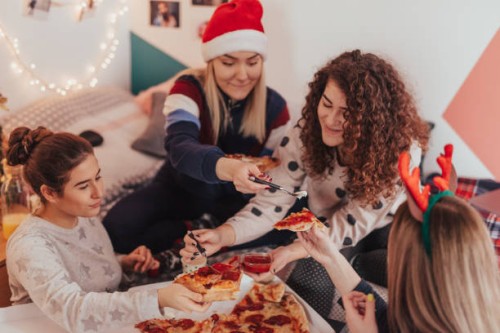 teenage girls eating pizza at sleepover christmas party - junk food stock pictures, royalty-free photos & images