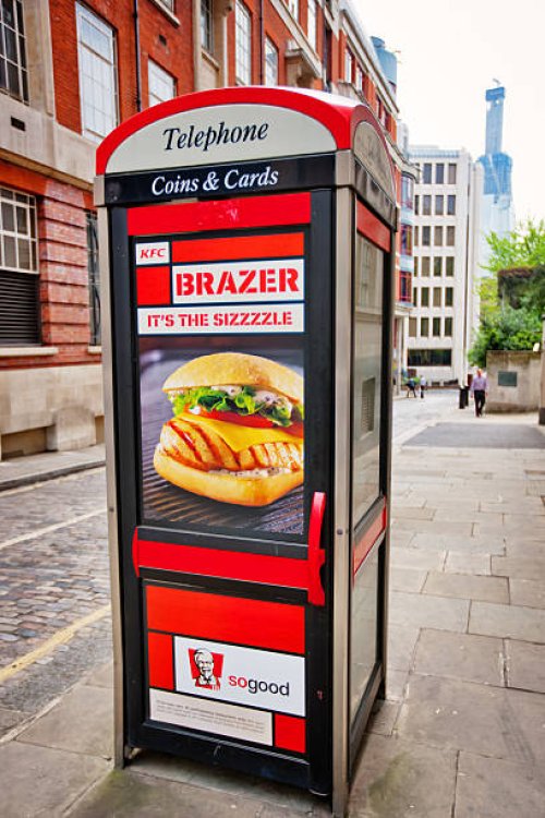telephone booth with fast food advertising, london - junk food stock pictures, royalty-free photos & images
