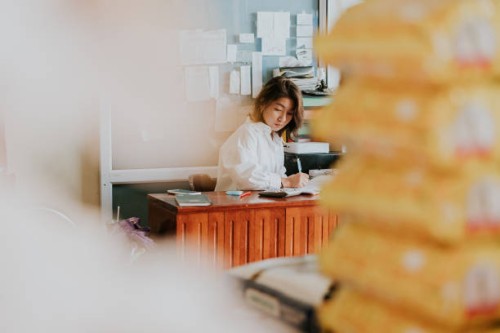 thai wholesale owner writing to bill for customer before sending rice - food stock pictures, royalty-free photos & images