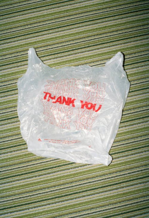 thank you in red letters on plastic bag on striped carpet - junk food stock pictures, royalty-free photos & images