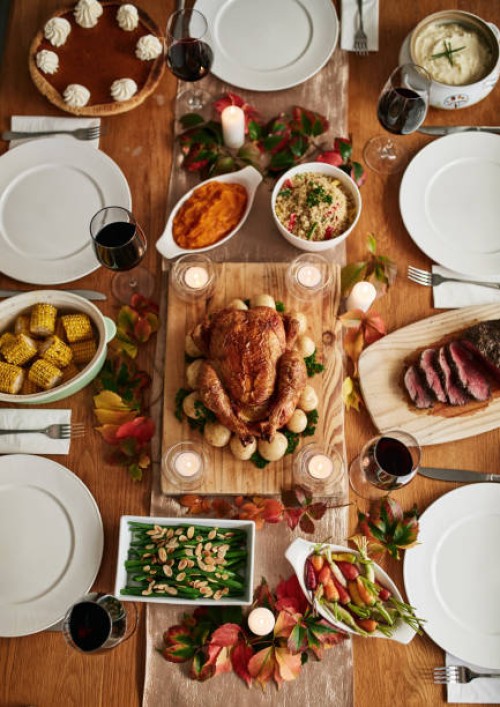 thanksgiving roast, celebration and a chicken on a table in the dining room from above for tradition. food, feast and turkey with a gourmet meal in a home for a social event or american holiday - food stock pictures, royalty-