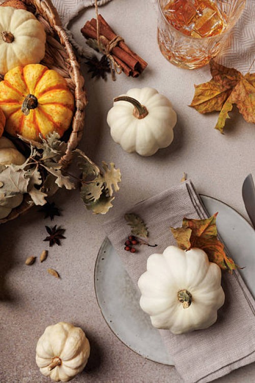 thanksgiving table with pumpkin plate setting and leaves - home decoration stock pictures, royalty-free photos & images