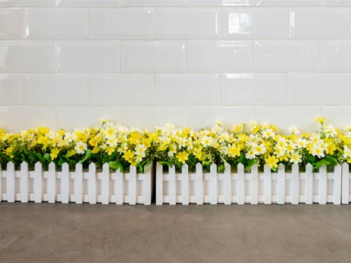 the artificial flower row in the white fence - garden decoration stock pictures, royalty-free photos & images