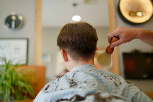 the barber is sweeping the hair - hairstyle stock pictures, royalty-free photos & images