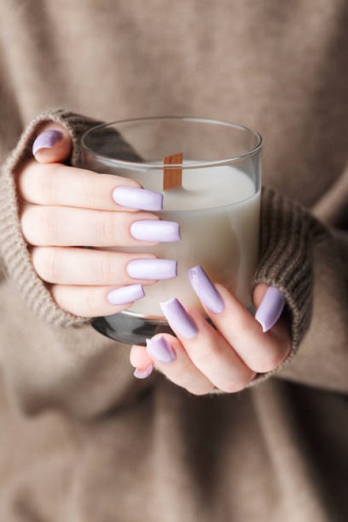 the hands of a young girl with a beautiful light purple manicure hold a candle,ukraine - nails art stock pictures, royalty-free photos & images