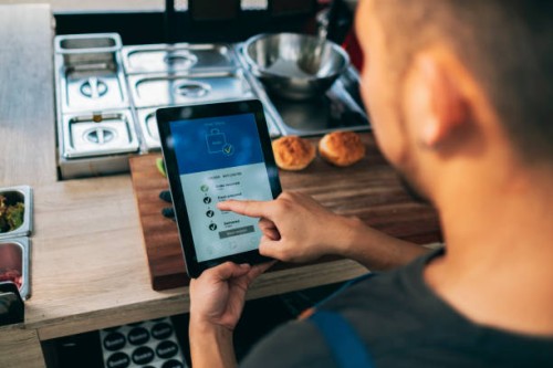 the owners of the food cart uses the food delivery platform to view the order - junk food stock pictures, royalty-free photos & images
