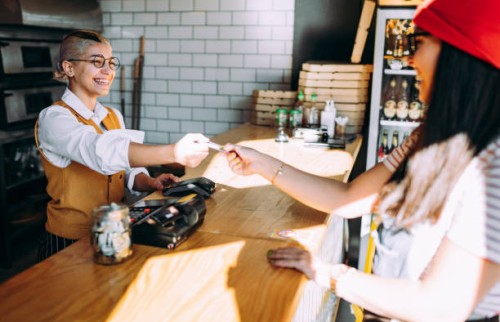 the woman pays for the food with a card - junk food stock pictures, royalty-free photos & images