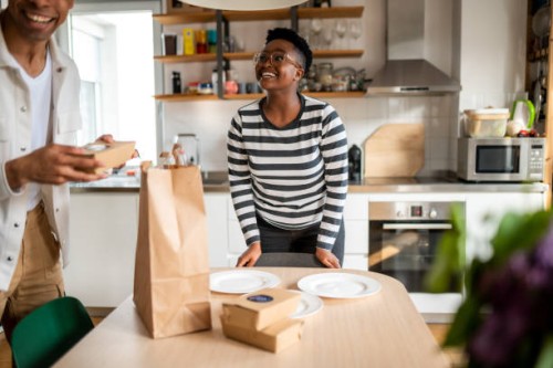 the young couple sets the table for lunch - junk food stock pictures, royalty-free photos & images