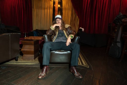 thoughtful, fashionable man sitting in armchair - concert stock pictures, royalty-free photos & images