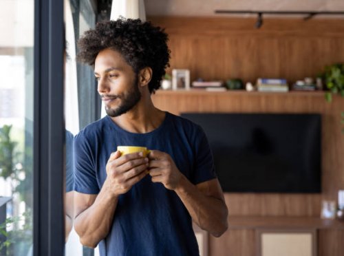 thoughtful man drinking a cup of coffee at home - coffee stock pictures, royalty-free photos & images