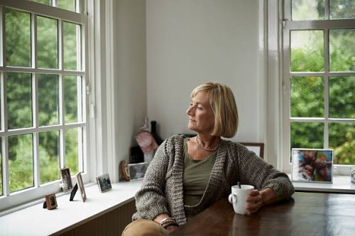 thoughtful senior woman having coffee - hairstyle stockfoto's en -beelden