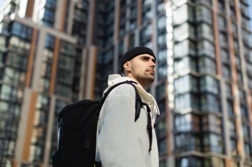 thoughtful young man in the new neighborhood - fashion stock pictures, royalty-free photos & images