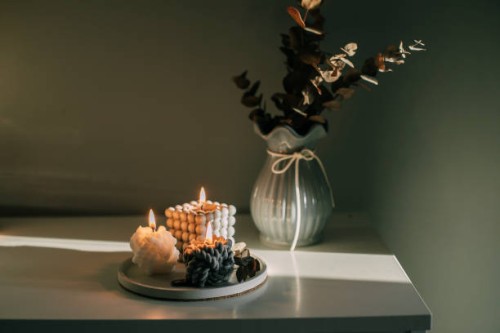 three burning candles on tray in darkroom. babble candle - home decoration stock pictures, royalty-free photos & images