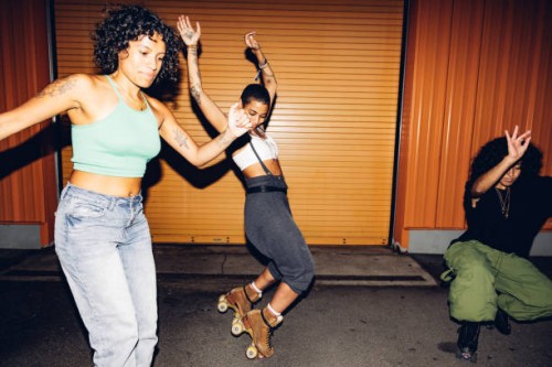 three freestyler on roller skate dancing at night - fashion stock pictures, royalty-free photos & images