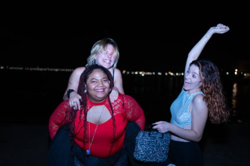 three friends having fun together at night on the beach - concert stock pictures, royalty-free photos & images