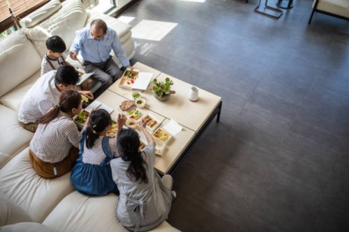 three generation family having lunch together - junk food stock pictures, royalty-free photos & images