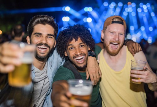 three happy young men partying on a music festival at night. - concert stock pictures, royalty-free photos & images